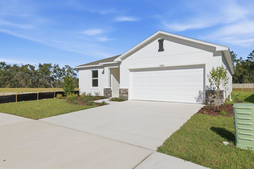 13640 Tropical Breeze Way Hudson, FL 34669 - Photo 37 of 48 a front view of a house with a yard