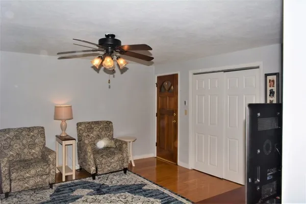a living room with furniture and a chandelier