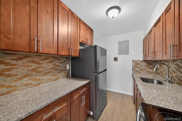 a kitchen with stainless steel appliances granite countertop a refrigerator and a sink