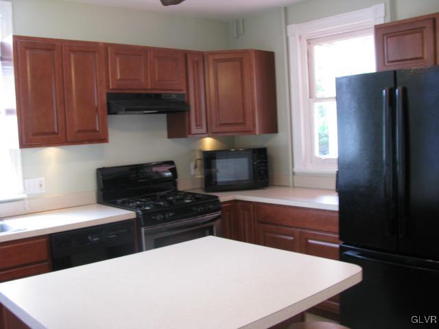 621 Friedensburg Road Reading, PA 19606 - Photo 6 of 17 a kitchen with stainless steel appliances a refrigerator a sink a stove a counter space and cabinets