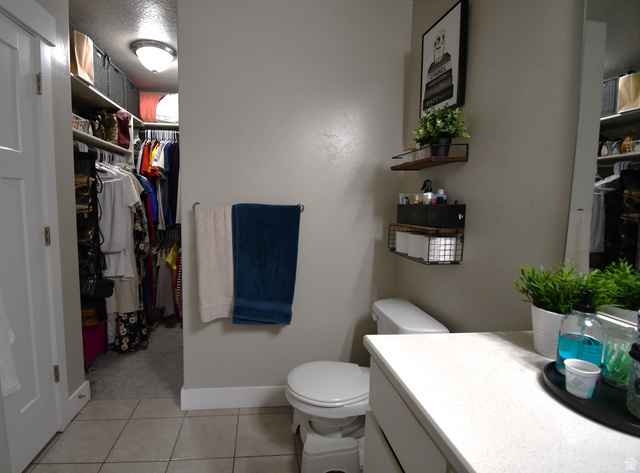 1688 West 200 North Mapleton, UT 84664 - Photo 11 of 18 Bathroom with a walk in closet, vanity, and light tile patterned floors
