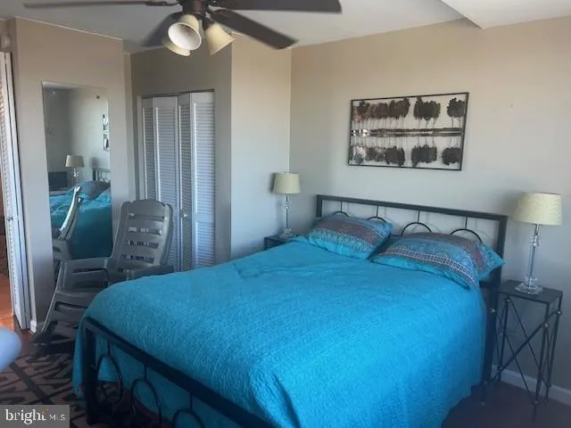 a bedroom with a bed and a lamp on table