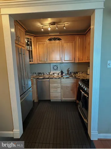a kitchen with stainless steel appliances a refrigerator sink and cabinets