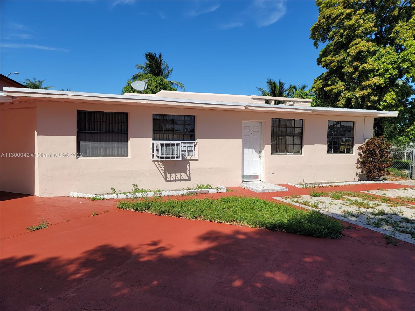 1120 South Le Jeune Road Hialeah, FL 33010 - Photo 1 of 54 a front view of a house with a yard and garage