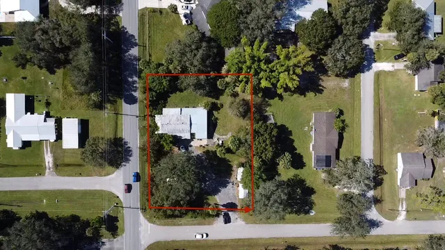 an aerial view of a house with a yard and garden