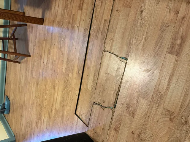 a view of a bathroom with wooden floor and a window