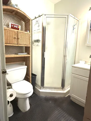 a white toilet sitting next to a bathroom sink