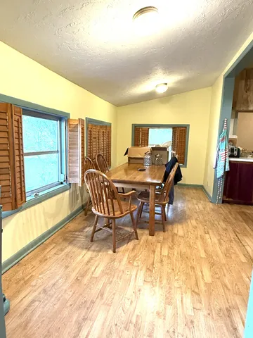a view of a dining room with furniture and a window