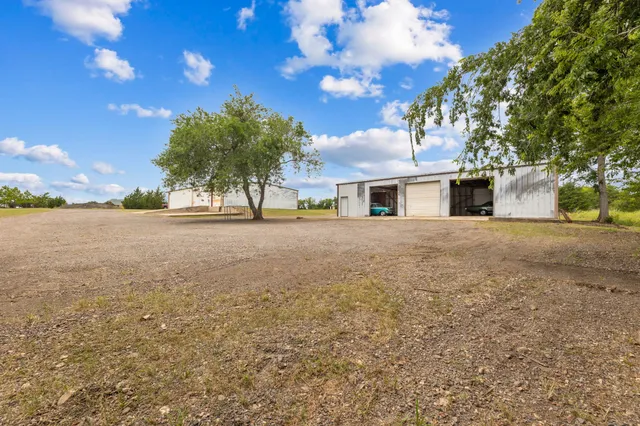 a view of a yard with a house in the background