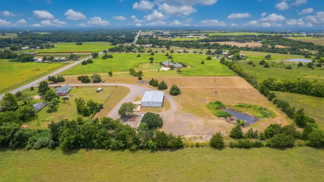 an aerial view of a city with lots of residential buildings ocean and mountain view in back