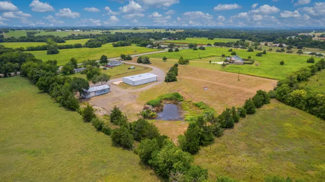 an aerial view of a houses with outdoor space and yard