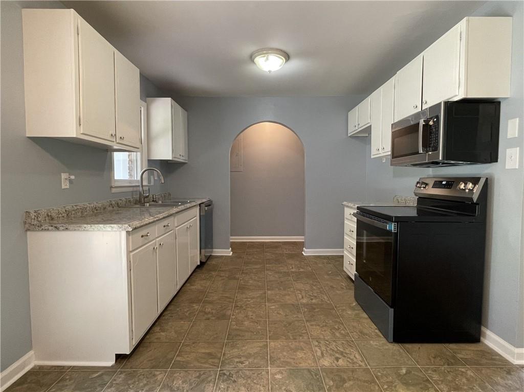 414 Landers Drive Southwest Mableton, GA 30126 - Photo 15 of 44 a kitchen with stainless steel appliances granite countertop a refrigerator and a stove top oven