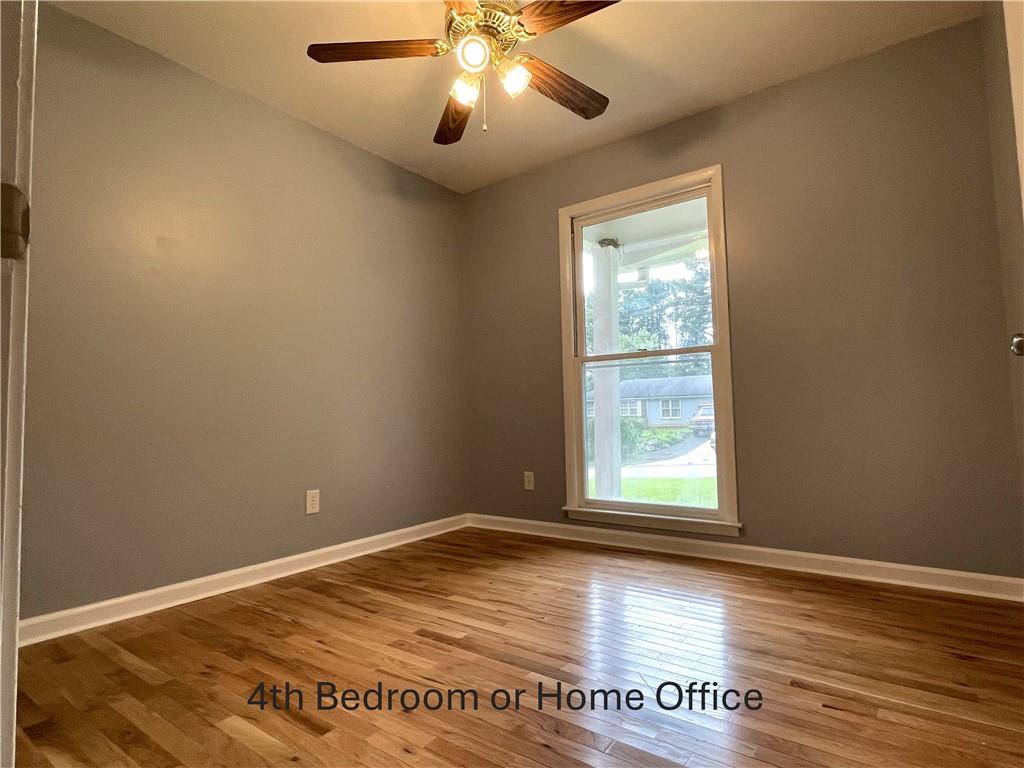414 Landers Drive Southwest Mableton, GA 30126 - Photo 20 of 44 an empty room with wooden floor and windows
