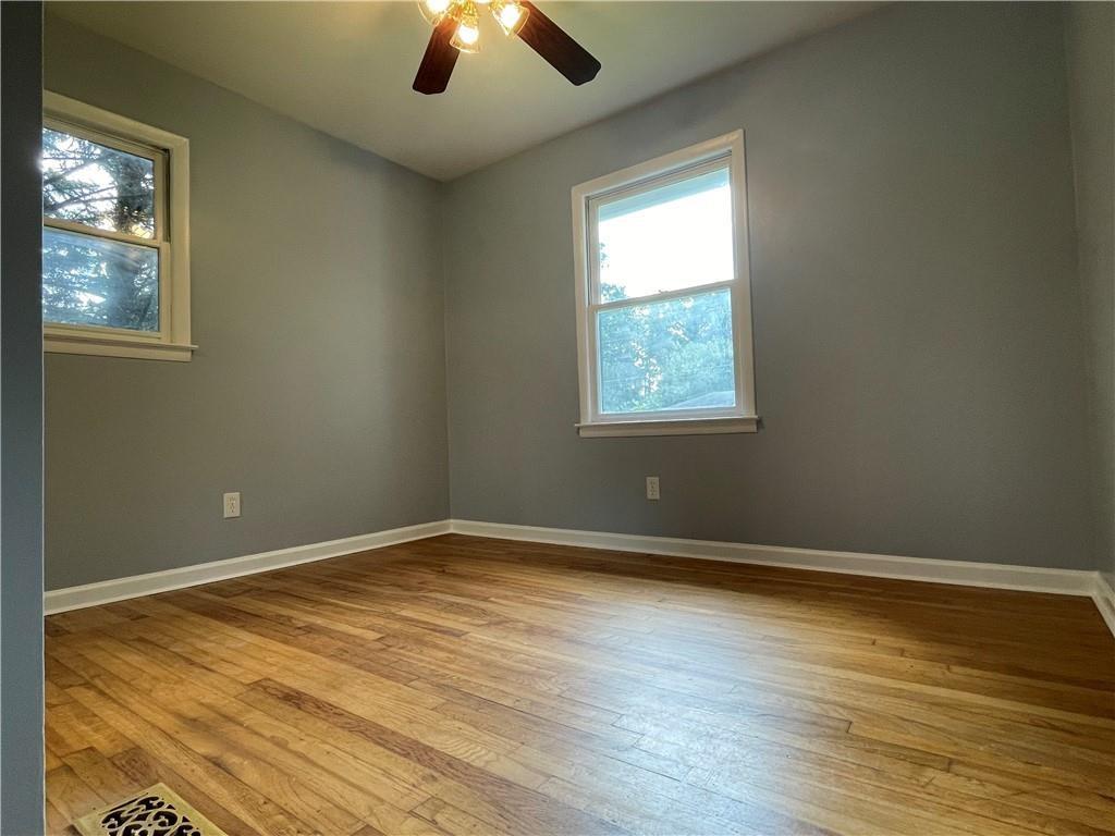 414 Landers Drive Southwest Mableton, GA 30126 - Photo 22 of 44 an empty room with wooden floor and windows