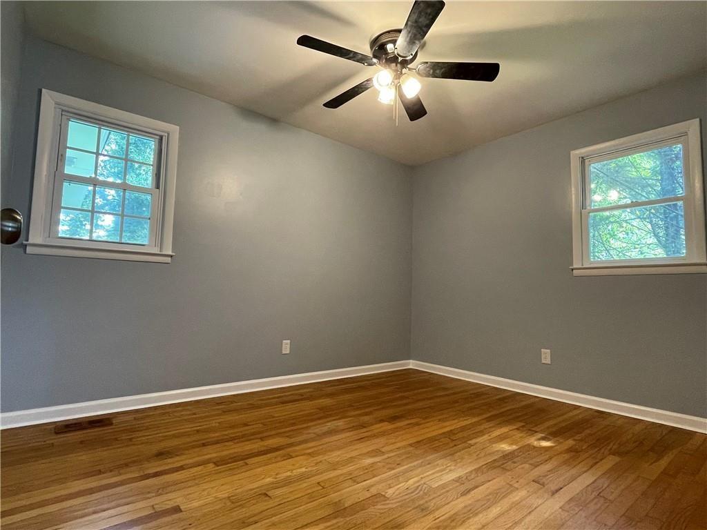414 Landers Drive Southwest Mableton, GA 30126 - Photo 24 of 44 an empty room with wooden floor fan and windows