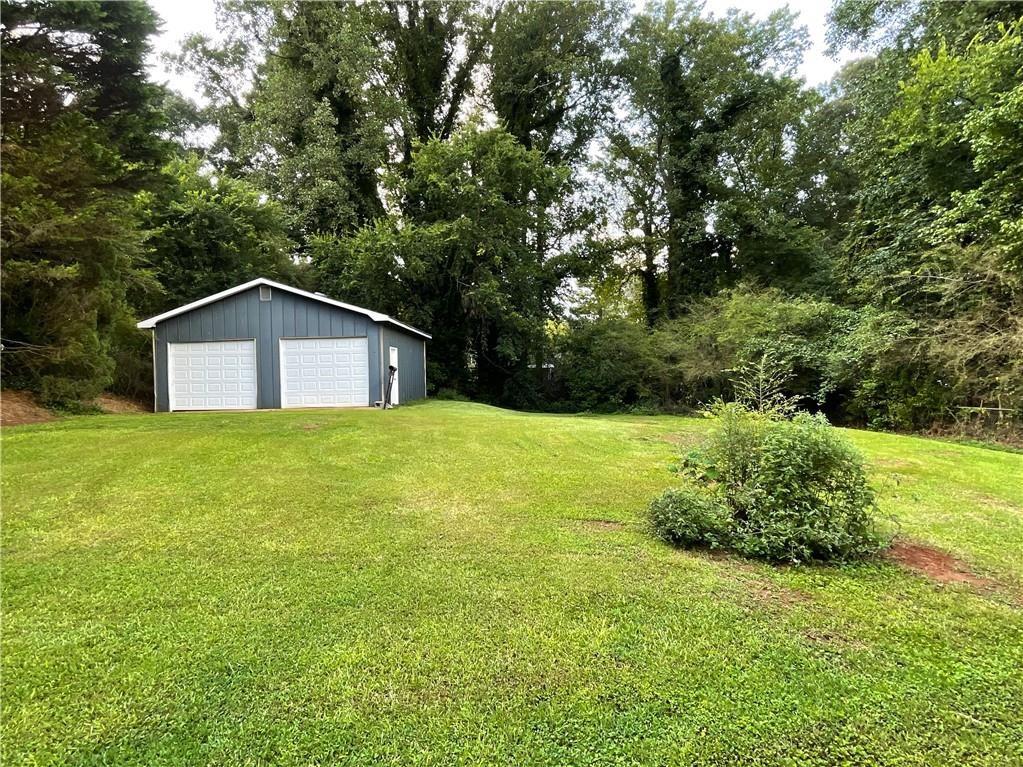414 Landers Drive Southwest Mableton, GA 30126 - Photo 37 of 44 a house with green field in front of it