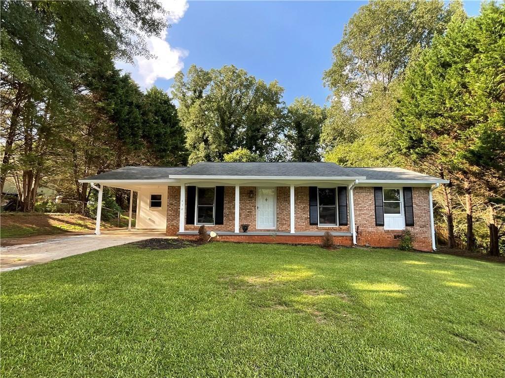 414 Landers Drive Southwest Mableton, GA 30126 - Photo 42 of 44 a front view of a house with a garden