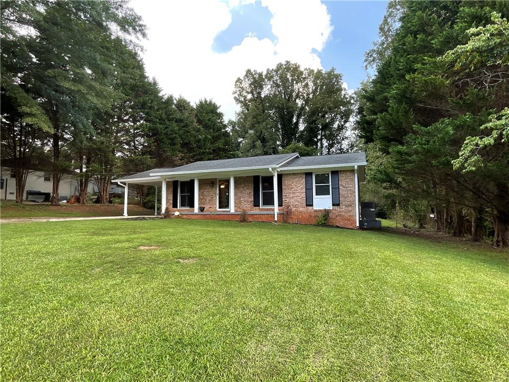 414 Landers Drive Southwest Mableton, GA 30126 - Photo 43 of 44 a front of a house with a garden