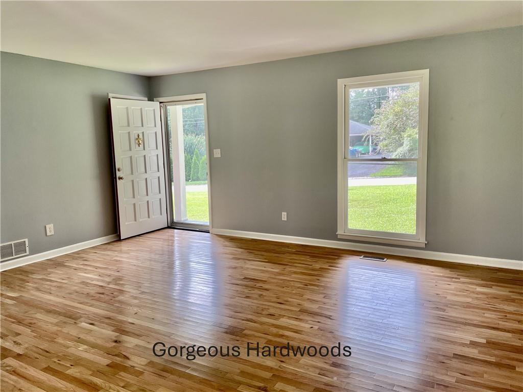 414 Landers Drive Southwest Mableton, GA 30126 - Photo 5 of 44 a view of an empty room with wooden floor and a window