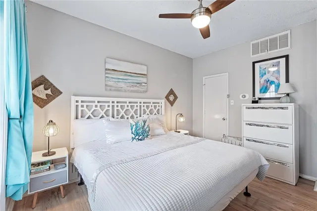 a bedroom with a large bed and a chandelier