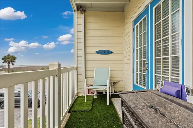 a view of a porch with a table and chairs