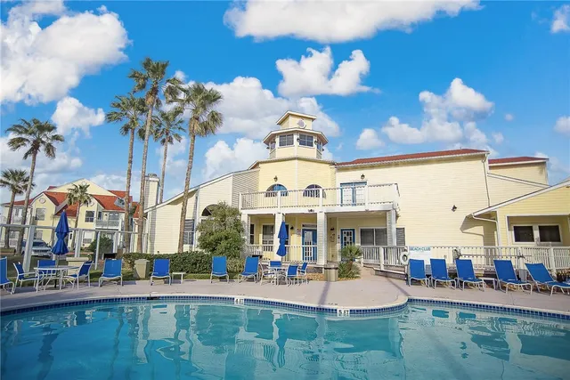 a view of a building with patio and yard
