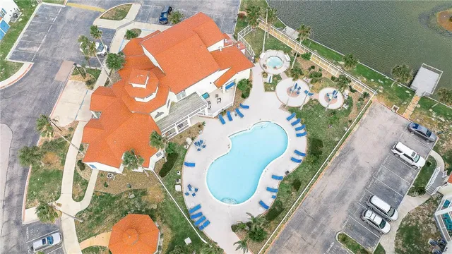aerial view of a swimming pool with outdoor seating