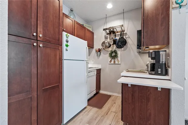 a white refrigerator freezer and a stove sitting inside of a kitchen