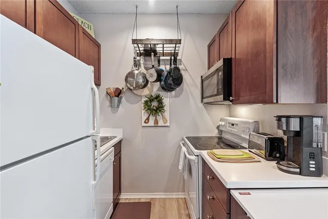 a kitchen with a refrigerator a stove top oven a sink and dishwasher