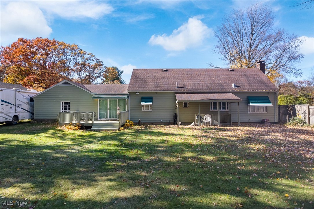 4851 Manchester Road Akron, OH 44319 - Photo 27 of 36 Rear view of property featuring a deck, a lawn, and a chimney