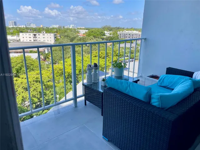 a living room with large windows and a table