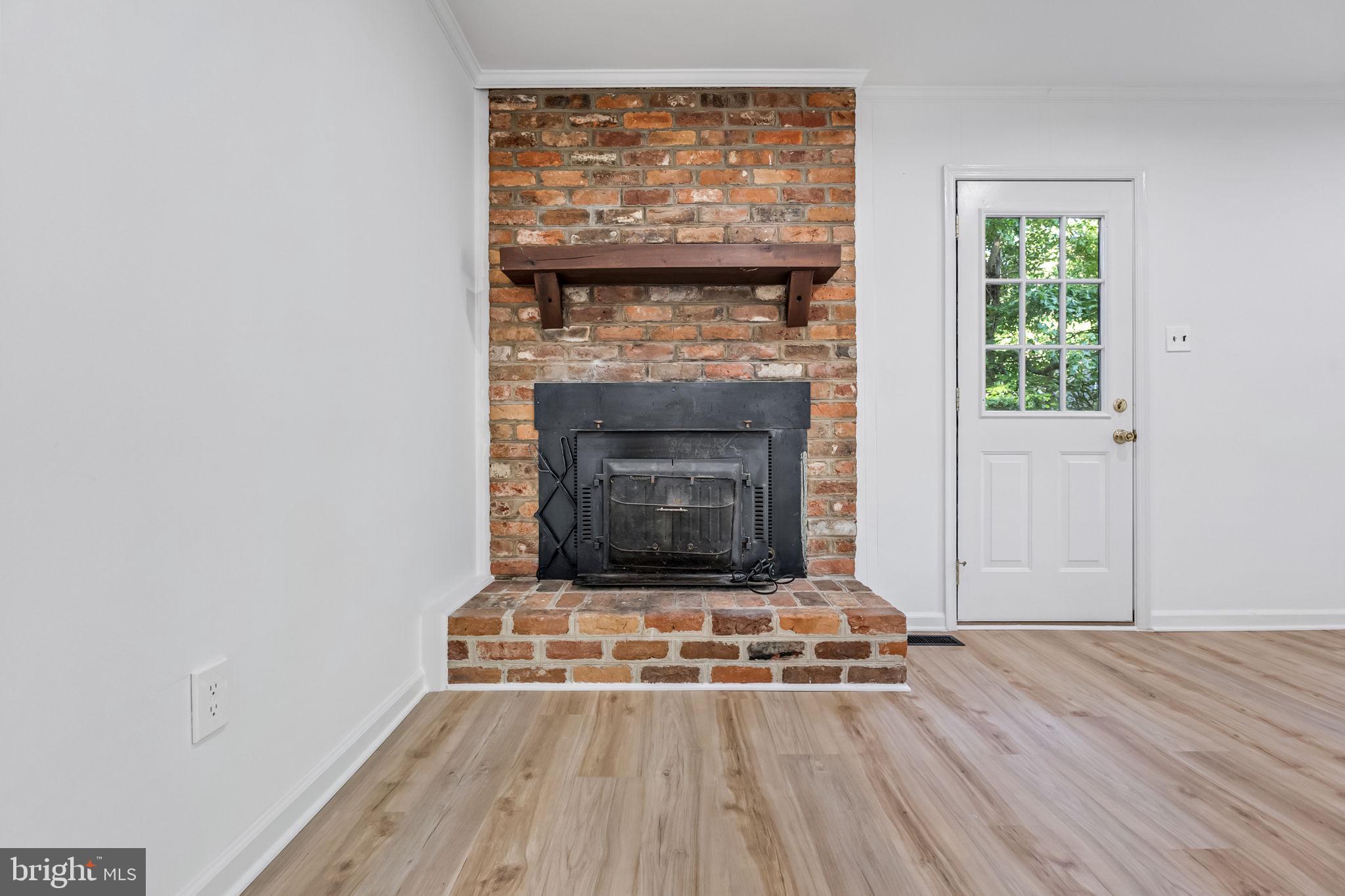 3 Boston Cove Ruther Glen, VA 22546 - Photo 6 of 30 a living room with a fireplace and a wooden floor