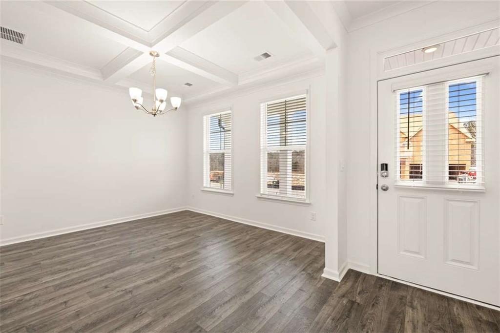 1851 Lacebark Elm Way Lawrenceville, GA 30045 - Photo 12 of 63 an empty room with wooden floor and windows