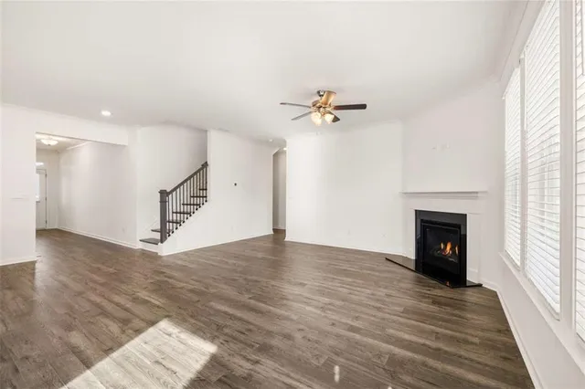 an empty room with closet and fan