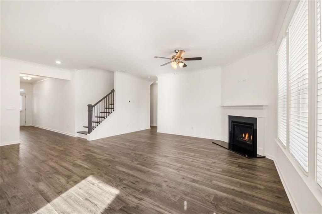 1851 Lacebark Elm Way Lawrenceville, GA 30045 - Photo 26 of 63 a view of empty room with wooden floor and fireplace