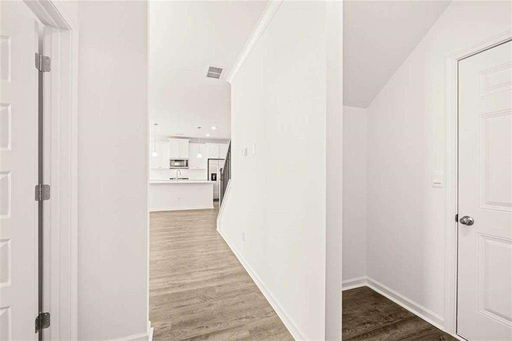 1851 Lacebark Elm Way Lawrenceville, GA 30045 - Photo 31 of 63 a view of a hallway with wooden floor