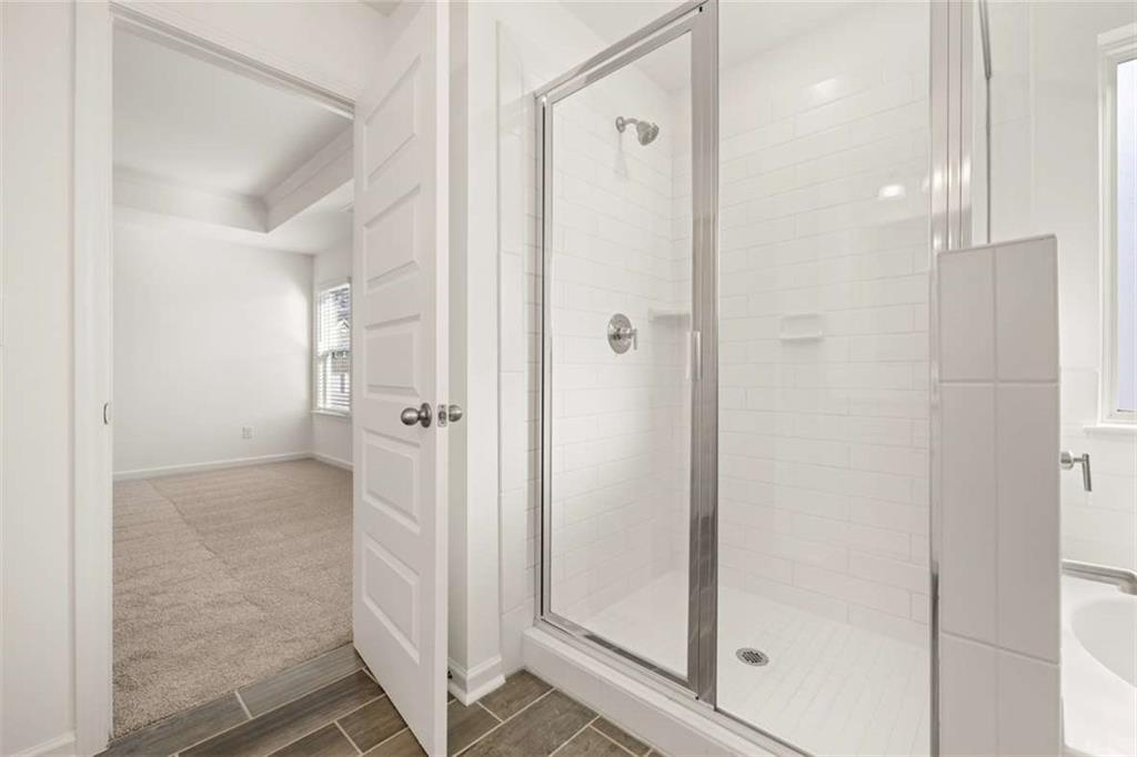 1851 Lacebark Elm Way Lawrenceville, GA 30045 - Photo 38 of 63 a view of a bathroom with a glass shower door
