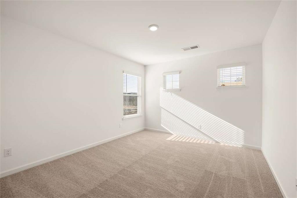 1851 Lacebark Elm Way Lawrenceville, GA 30045 - Photo 47 of 63 an empty room with windows