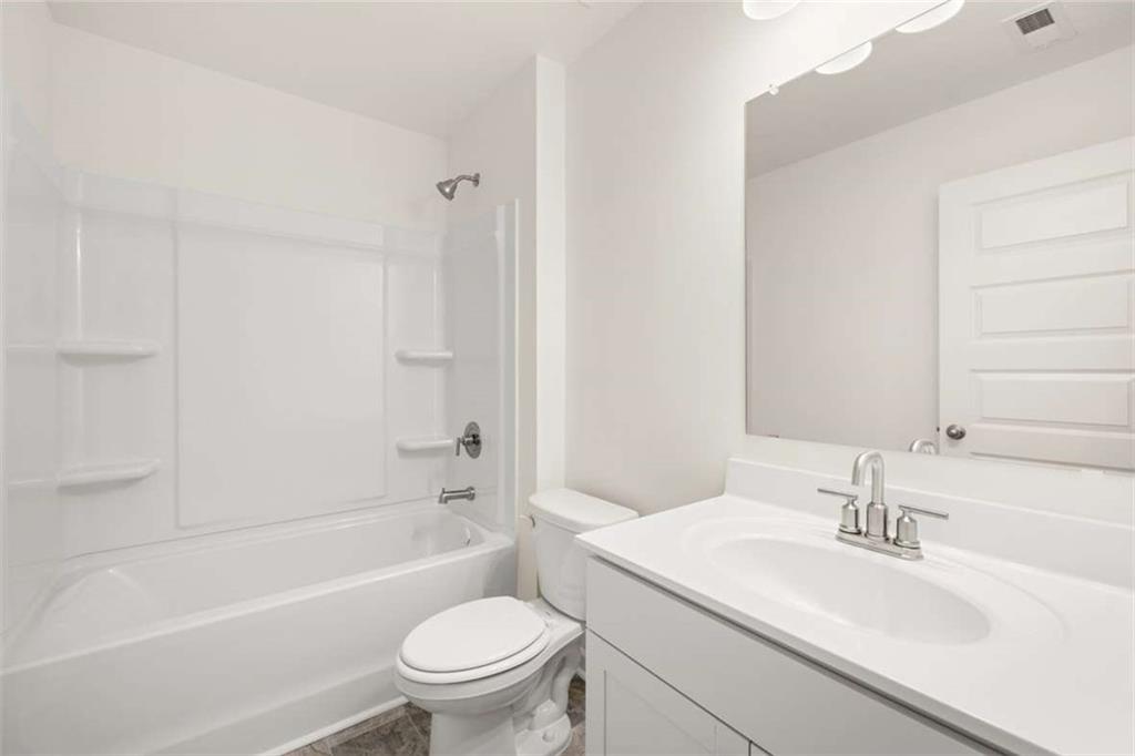 1851 Lacebark Elm Way Lawrenceville, GA 30045 - Photo 49 of 63 a bathroom with a sink a toilet and a bathtub