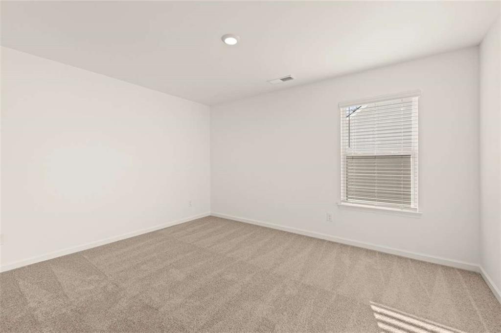 1851 Lacebark Elm Way Lawrenceville, GA 30045 - Photo 50 of 63 an empty room with a window