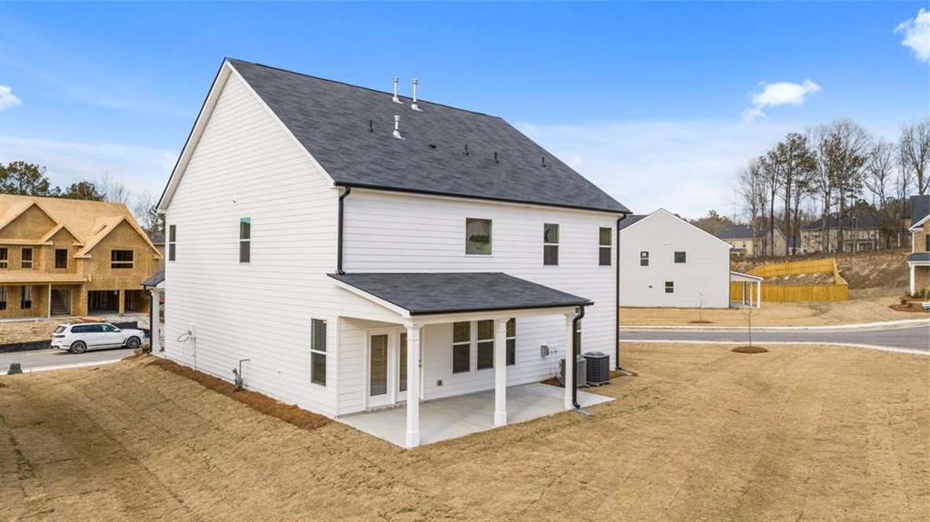 1851 Lacebark Elm Way Lawrenceville, GA 30045 - Photo 56 of 63 a view of a white house with a large windows and palm trees