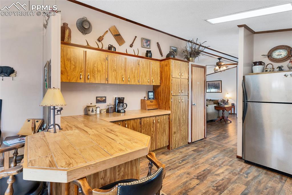 75 6th Street Como, CO 80432 - Photo 14 of 35 a kitchen with stainless steel appliances granite countertop a refrigerator a sink and a stove