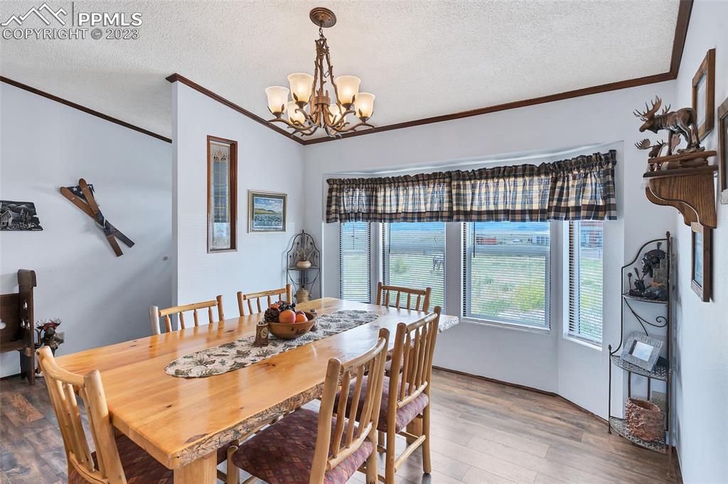 75 6th Street Como, CO 80432 - Photo 15 of 35 a view of a dining room with furniture a chandelier and wooden floor