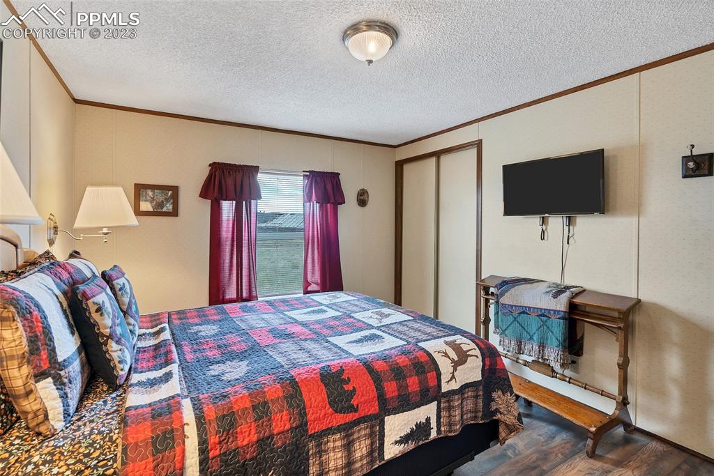 75 6th Street Como, CO 80432 - Photo 24 of 35 a bedroom with a bed and a flat screen tv