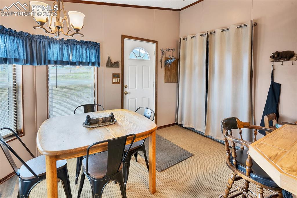 75 6th Street Como, CO 80432 - Photo 9 of 35 a view of a dining room with furniture and a chandelier