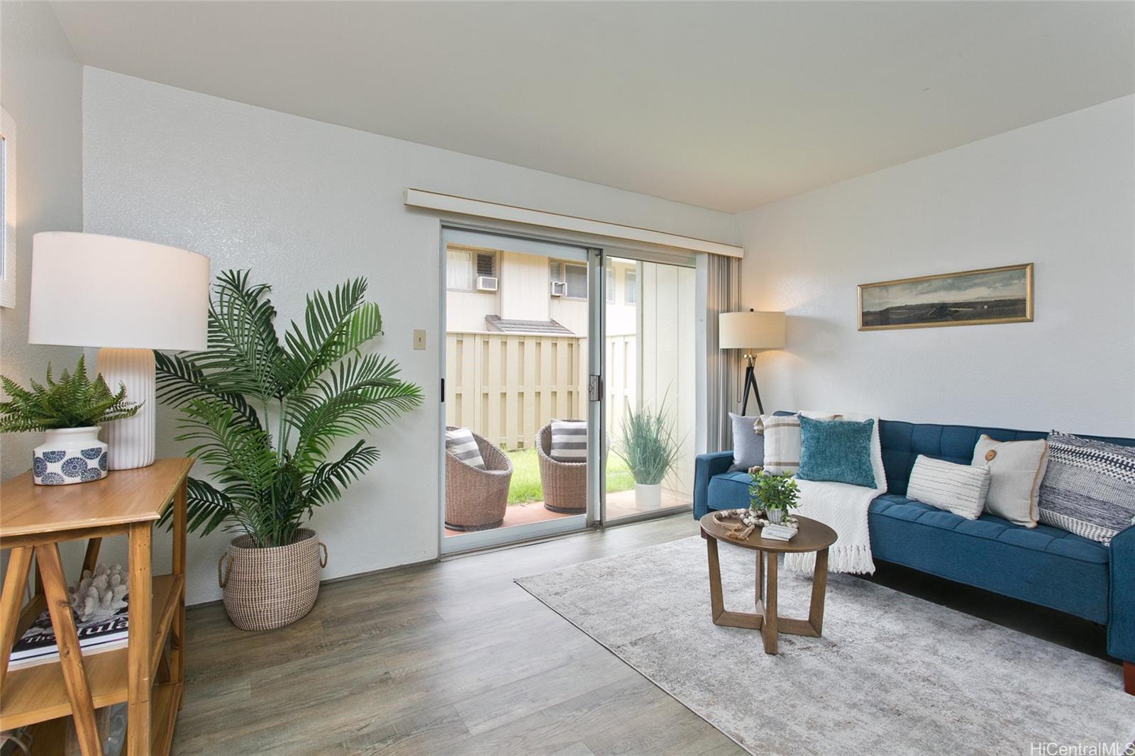 a living room with furniture and a potted plant