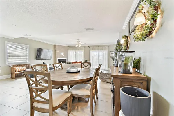 a large kitchen with kitchen island granite countertop a refrigerator a sink a stove a dining table and chairs