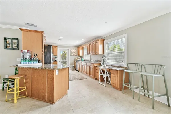 a kitchen with stainless steel appliances granite countertop a refrigerator stove and sink