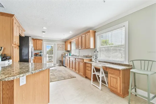 a view of a patio with table and chairs with wooden floor and fence