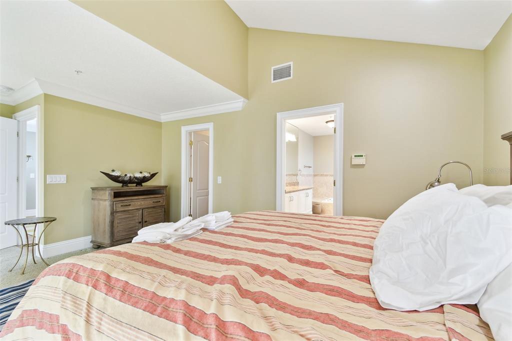 16033 Gulf Boulevard Redington Beach, FL 33708 - Photo 38 of 98 a bedroom with a bed and a chair